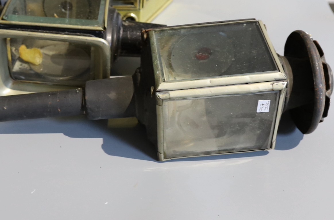 A Victorian brass carriage lamp, with turned wood handle, height 41cm, together with two other carriage lamps